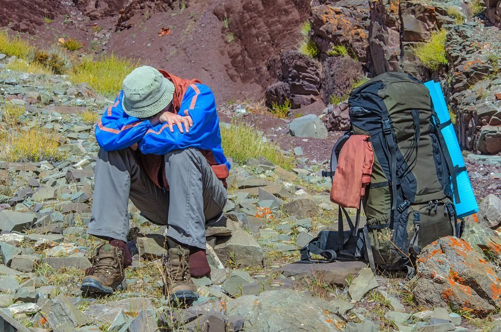 Hiker resting on a high altitude mountain trail