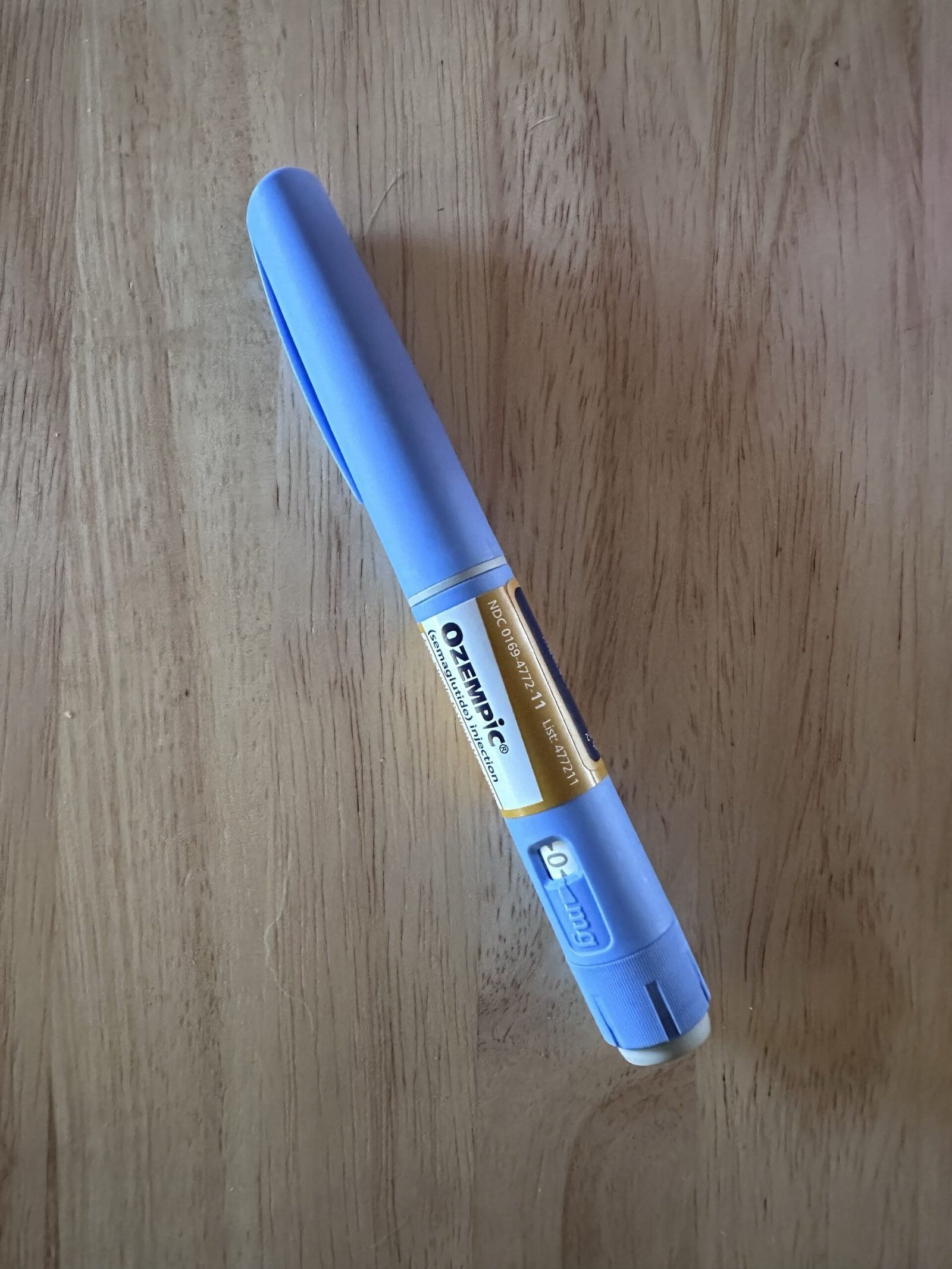 Ozempic (semaglutide) GLP-1 injection pen on a wood table